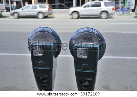 Car park meter with cars in the background. For transportation concepts.