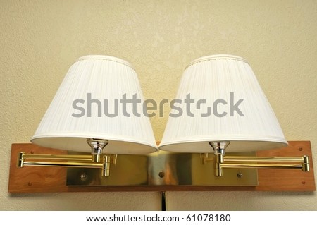 Double light lamps with lamp shades commonly found in hotel rooms.
