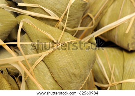 Bunch of delicious vegetarian dumplings wrapped in bamboo leaf.