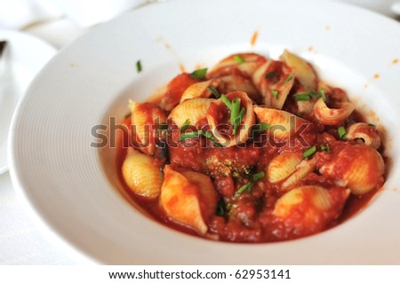 Delicious Italian pasta cooked in hot tomato sauce and topped with spices.