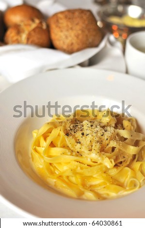 Simple pasta in cream sauce with generous shredded cheese topping.