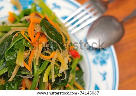 Oriental healthy vegetable mix in porcelain dish.