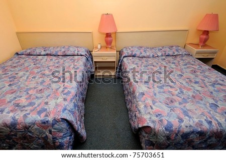 Interior of simple and comfortable room with twin beds.