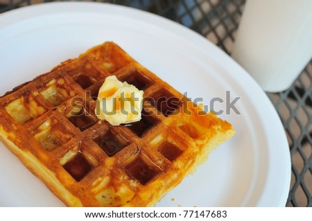 Western style waffle pancake with butter and delicious syrup for breakfast.