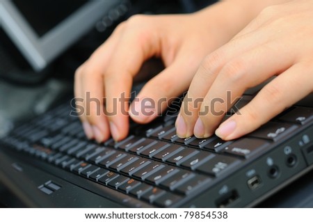 Both hands of a male typing and working on office new keyboard. Focus is on left fingers.