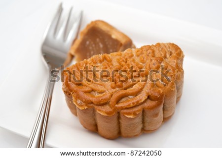 traditional Oriental moon cake on white plate for dessert.