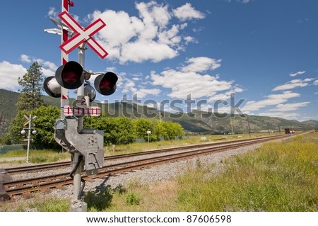 Railway signal control along railroad track leading into the mountain range.