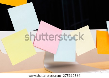 Colored post it notes covering notebook screen.