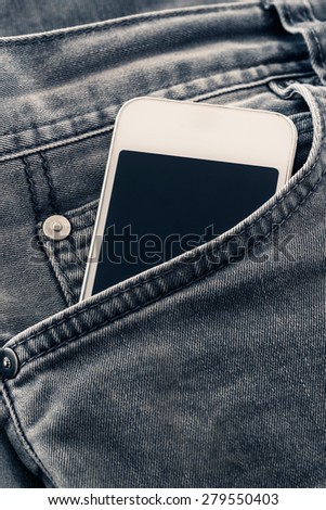 Mobile phone on jean pocket.