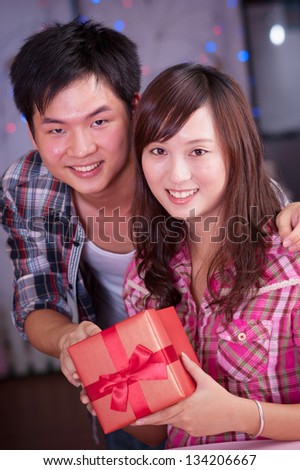 young asian girl and boyfriend with a present box