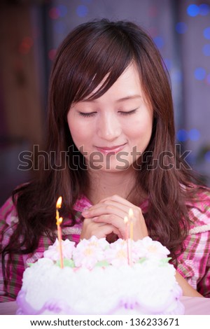 asian girl make a wish at birthday party