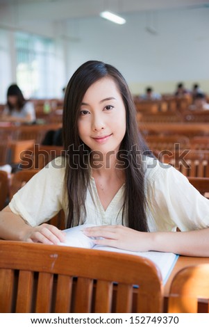 smiling Chinese female college student in the classroom
