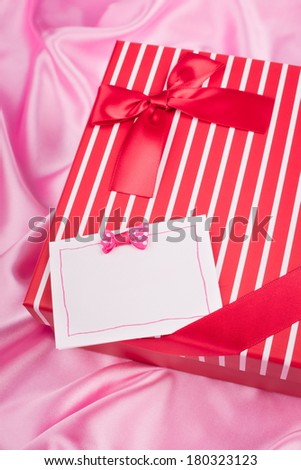nice gift box and card on pink silk cloth