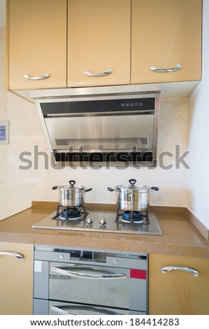 the cabinet and cooker in the kitchen
