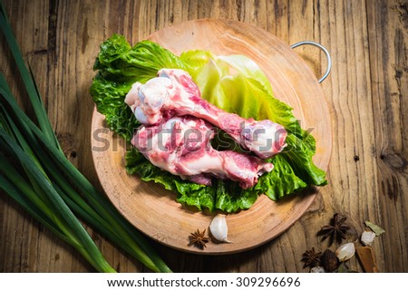 raw pig bone on chopping block