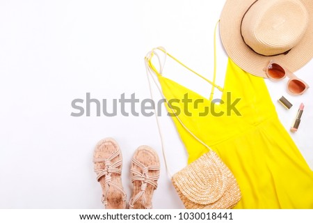 International womens day sale. Woman clothes & accessories, spring summer collection. Yellow dress, straw hat & shoulder bag, brown sunglasses eyewear. Nail polish, lip gloss. Flat lay, background.