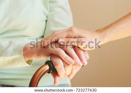 Senior woman with her caregiver at home. Concept senior people health care.