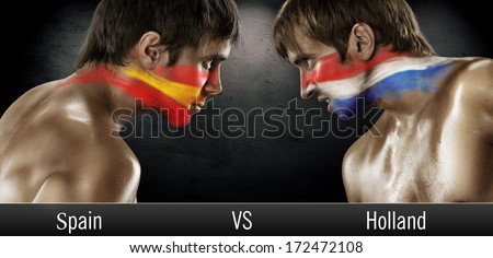 Two soccer fans with flags face to face. Spain and Holland, World Cup 2014