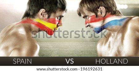 Two soccer fans with flags face to face. Spain and Holland