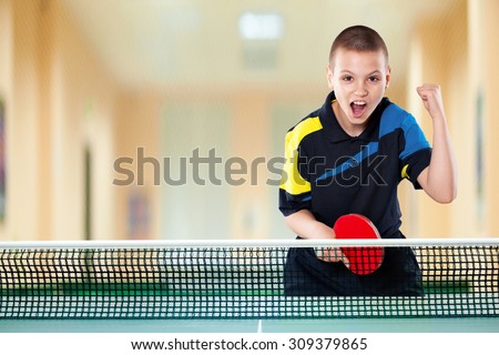 Portrait Of Kid Playing Tennis celebrating flawless victory in table tennis