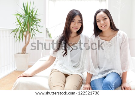 attractive asian women relaxing in the bed room