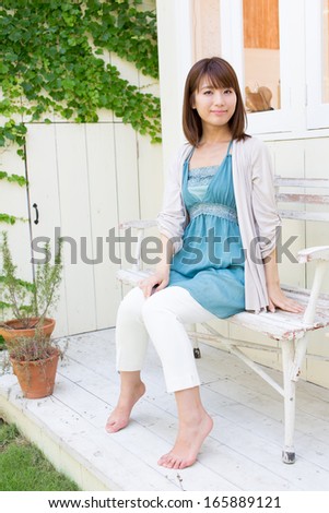 young asian woman relaxing in the garden