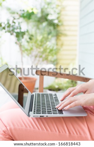 close up of a woman using laptop computer in the garden