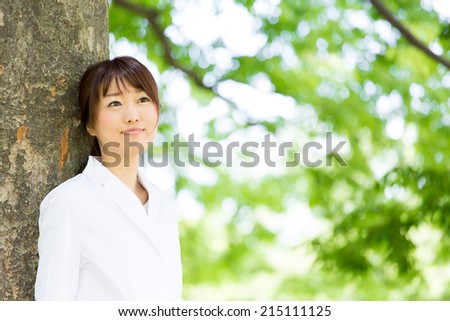 young asian nurse relaxing in the park