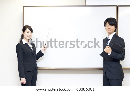 a portrait of young business people standing front of the whiteboard