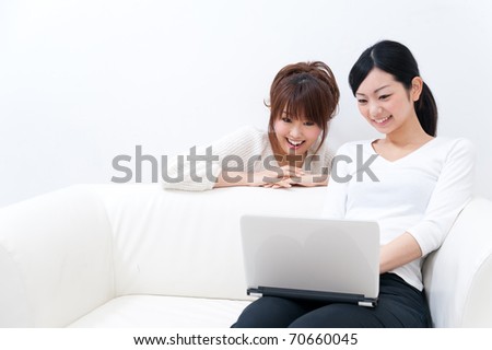 two beautiful asian women using laptop computer