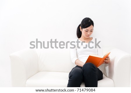 portrait of beautiful asian woman reading a book