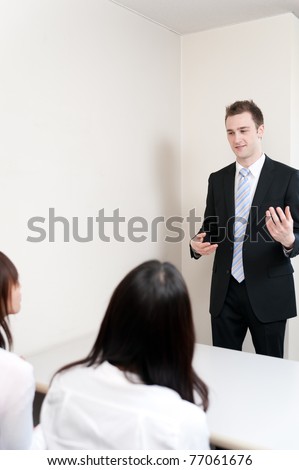 young teacher speaking to asian woman in the meeting room