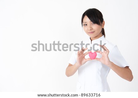 attractive asian nurse with symbol of heart