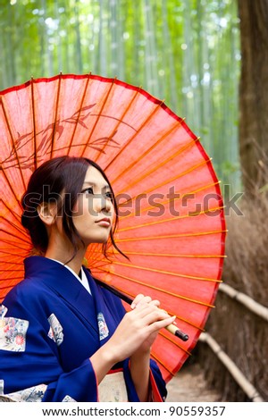 japanese kimono woman with red umbrella in bamboo forest