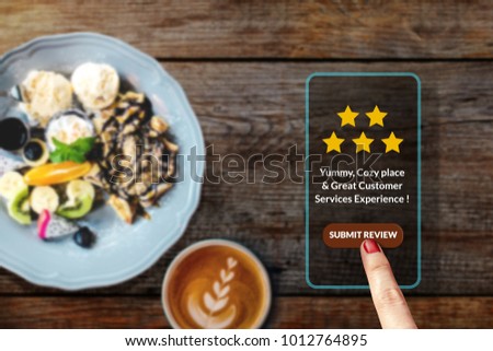 Customer Experience Concept. Woman using Smartphone in Cafe or Restaurant to Feedback Five Star Rating in Online Satisfaction Survey Application, Food Review, Top View