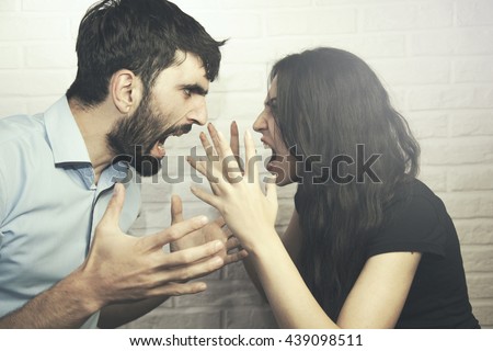 attractive angry couple fighting and shouting at each other