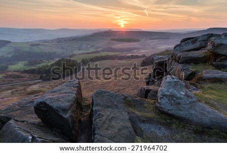 Sunset on Stanage Edge, with views of Win and Lose Hill in the distance. Peak District, Derbyshire. A magnificent stretch of rock formation suitable for all kinds of outdoor pursuits.