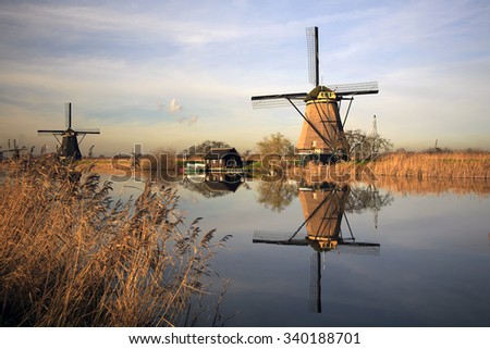 Dutch windmills reflected in canal, Unesco World Heritage Site Kinderdijk, South Holland, Netherlands