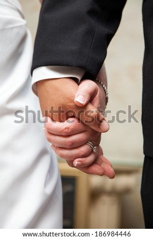 A married couple holding hands.
