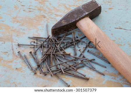 hammer and nails on a thin wooden table