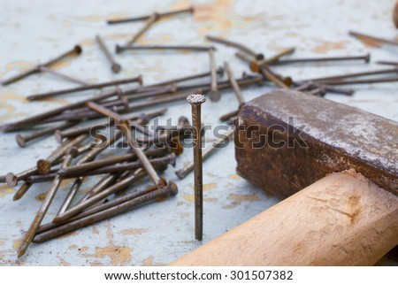 hammer and nails on a thin wooden table