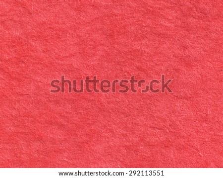 Closeup of Craft eco textured red colored paper. Close-up of Handmade paper texture. Spots on red background. Useful for scrapbooking and greeting or oriental cards. Sa Paper. Mulberry paper.