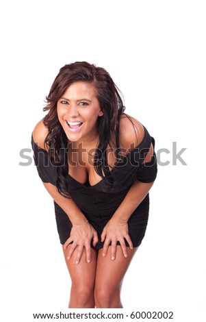 Woman in black dress doubled over, apparently laughing uncontrollably. Shot against a white background.