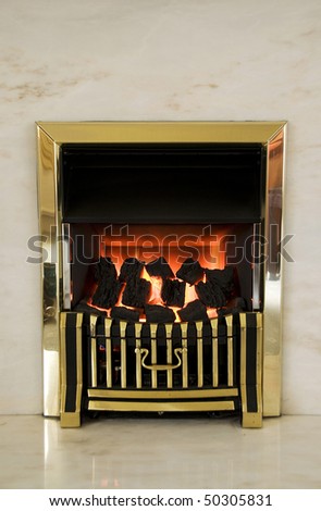 Burning gas fire and marble fireplace.