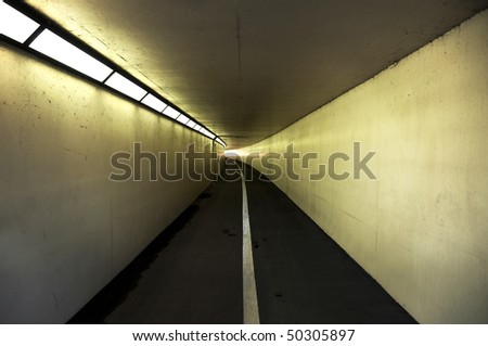 Pedestrian and cycle tunnel receding to vanishing point.