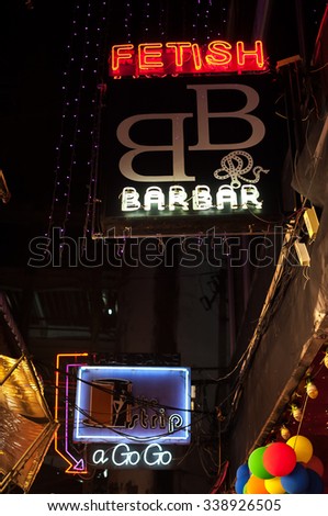 BANGKOK, THAILAND - JUNE 14, 2015 - Neon signs outside the bars of Patpong in Bangkok. Patpong is one of Bangkok\'s most well-known red light districts and entertainment areas for foreigners.
