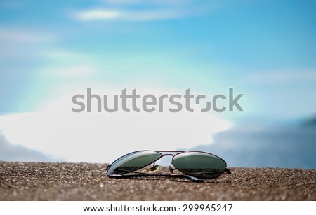 sun glasses on a sea coast blue sky background