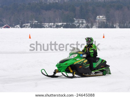 LAKE GEORGE, NY - February 7, 2009: A snowmobile rider exits the ice on Lake George in order to enjoy the February 7 , 2009 Lake George Winter Carnival.