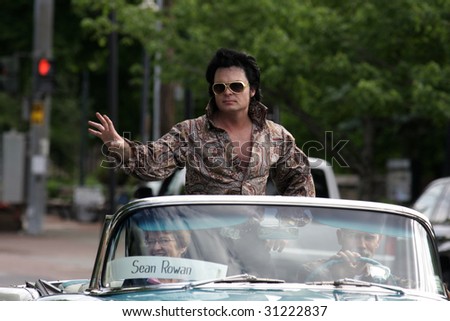 LAKE GEORGE, NY - MAY 30 : An Elvis impersonator rides in the Elvis Classic Car Parade during the 2009 Lake George Elvis Festival May 30, 2009 in Lake George, NY.