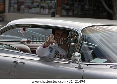LAKE GEORGE, NY - MAY 30 : An Elvis impersonator rides in the Elvis Classic Car Parade during the 2009 Lake George Elvis Festival May 30, 2009 in Lake George, NY.